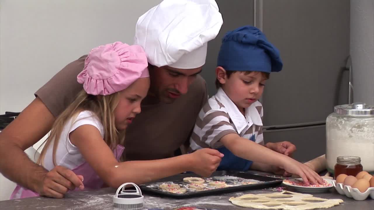 Handsome father preparing a meal with his sons