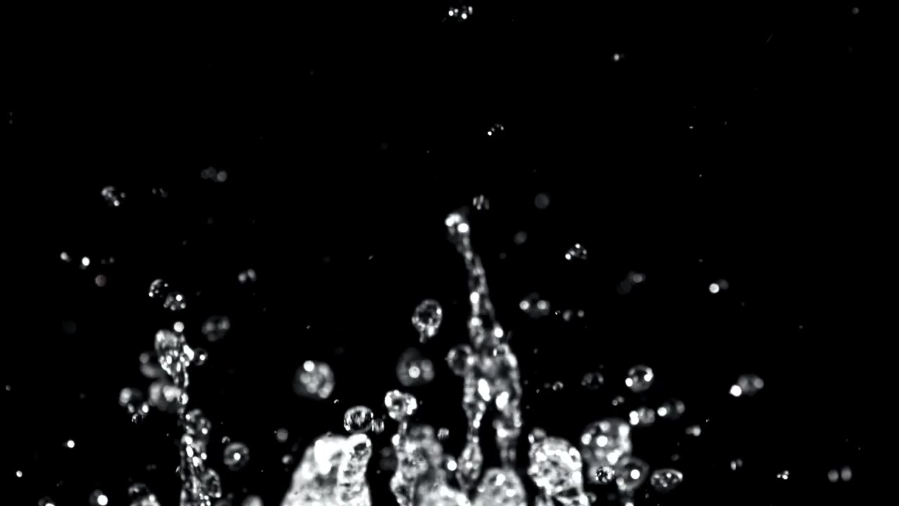 Clear Water Droplets Splashing in Slow Motion on Black Background