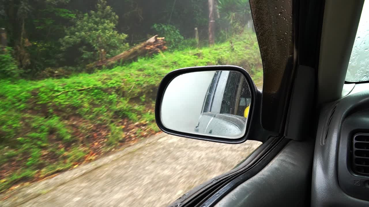 Ripresa POV di un'auto che guida nella nebbia nella foresta pluviale della Costa Rica.