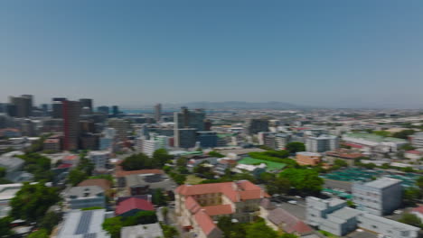 Pan-shot-of-development-in-city.-Residential-neighbourhood-under-slope-of-hill-and-commercial-borough-with-tall-office-buildings.-Cape-Town,-South-Africa