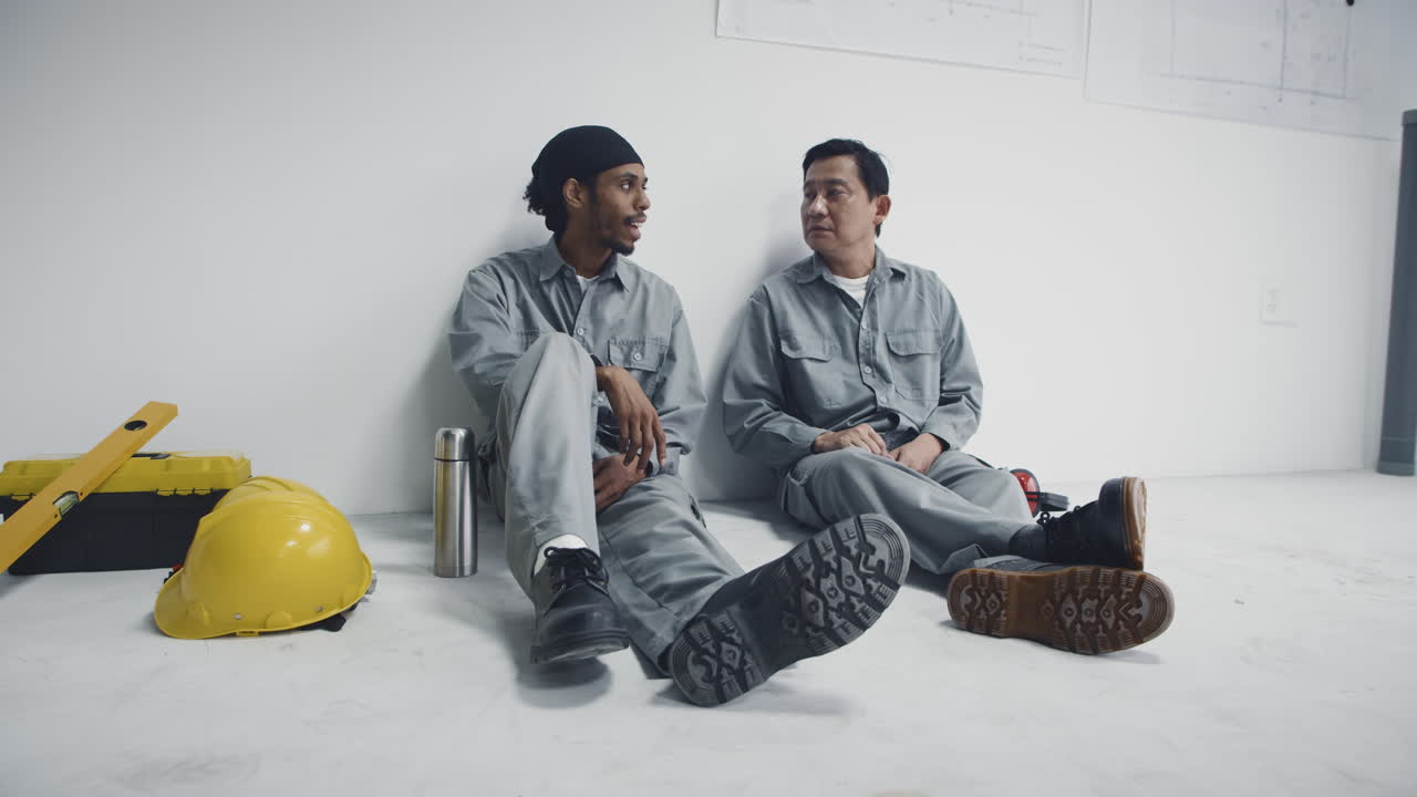 Diverse Construction Workers Sitting on Floor