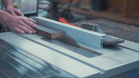 Bringing-teak-timber-trim-length-to-table-saw-begin-cut-SLOW-MOTION