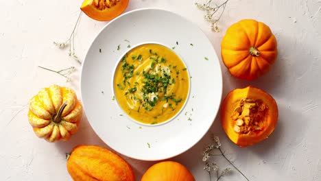 pumpkin soup in plate with vegetables around