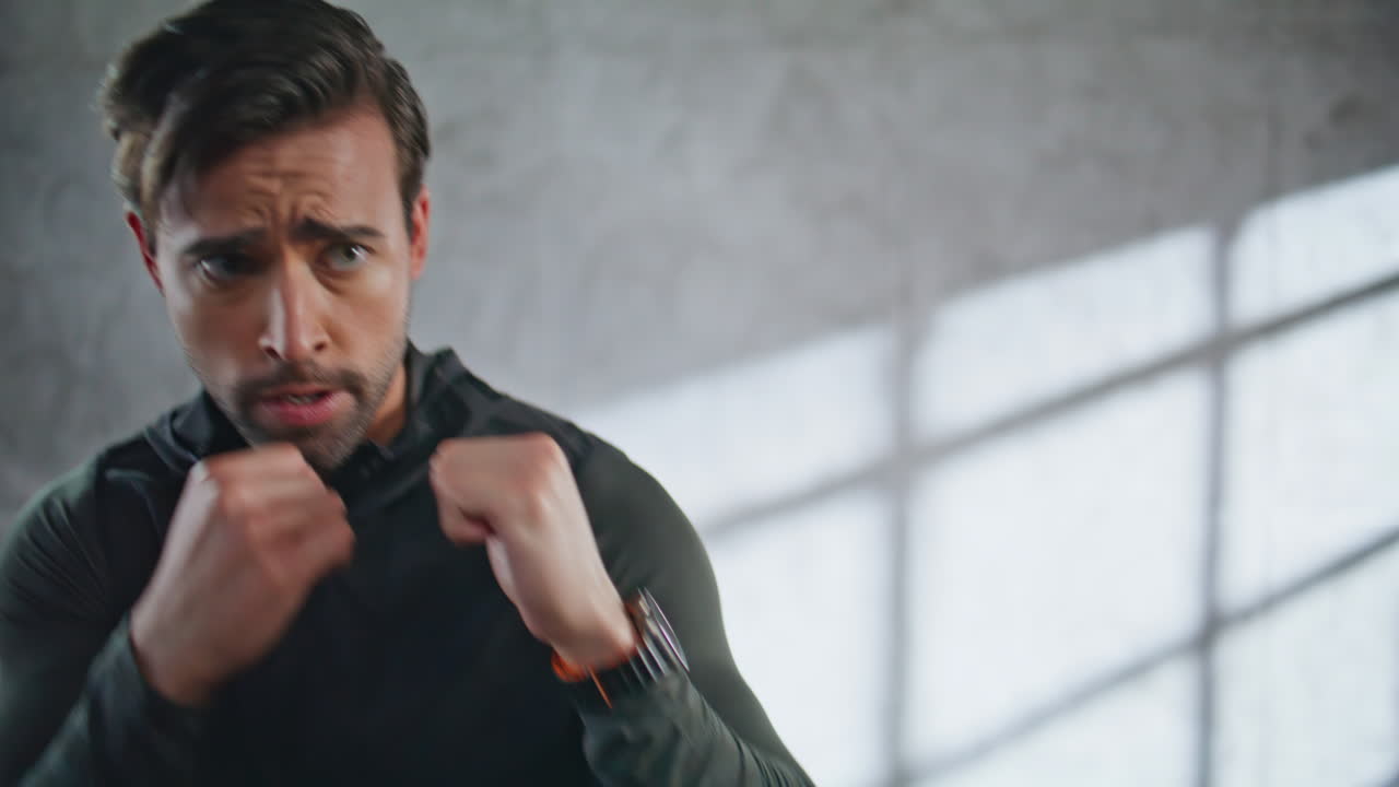 Emotional fighter hitting air gym closeup. Sportsman exercising fighting workout