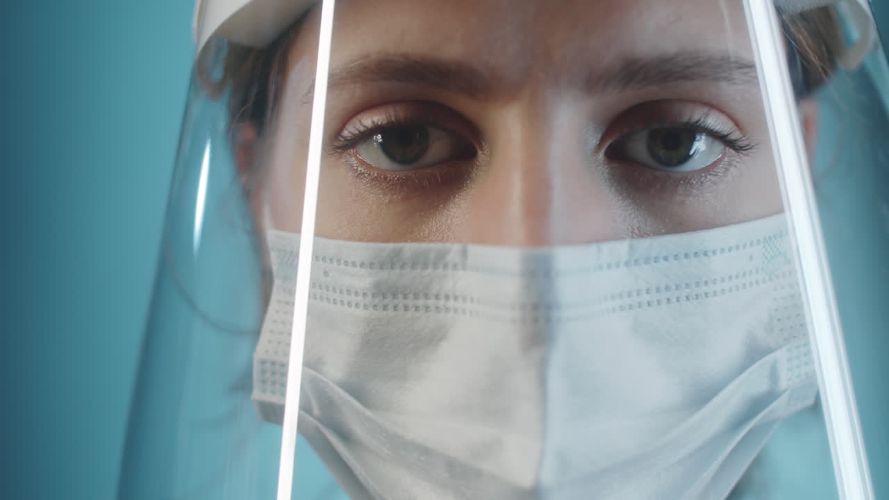 Female Doctor in Face Shield and Mask Posing for Camera