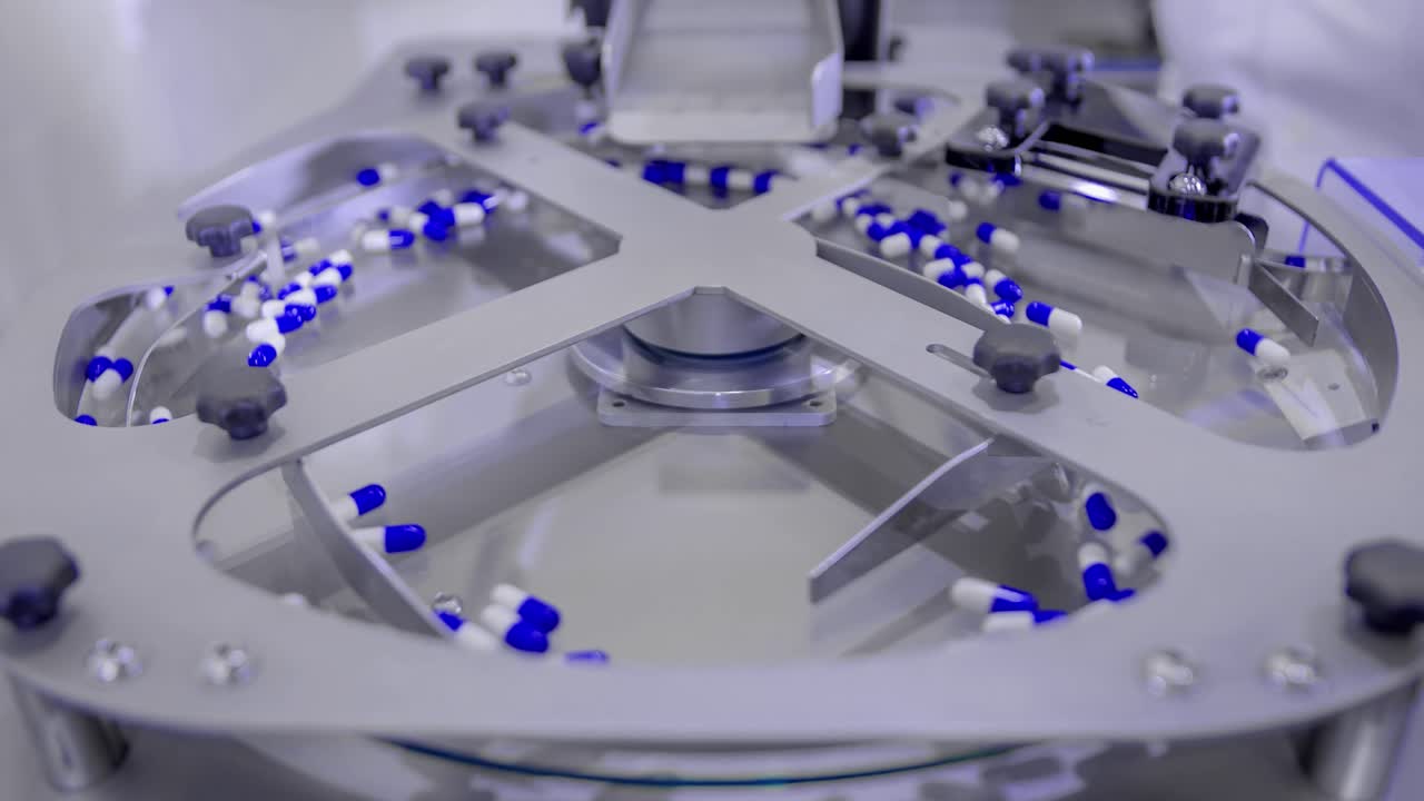 Blue pills for COVID-19 treatment spinning on a plate during counting process on the production line