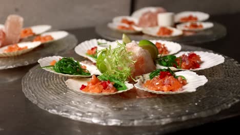 chef preparing a seafood platter with scallops and salmon