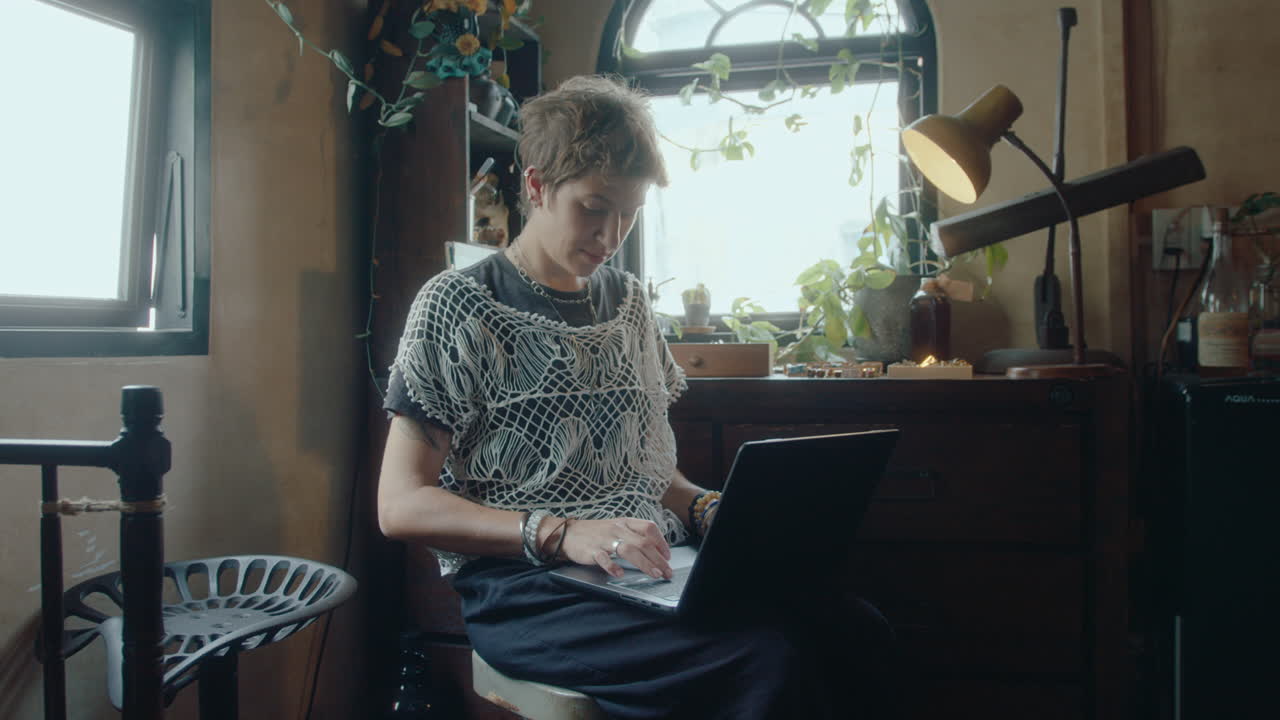 Young Woman Working with Laptop in Antiques Shop