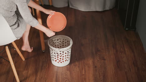 woman disposing of carrot scraps