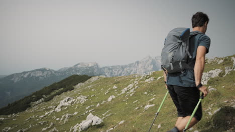 Camera-tracking-forward,-hiker-walking-past-the-camera-at-the-end-there-is-a-view-at-the-nearby-mountains