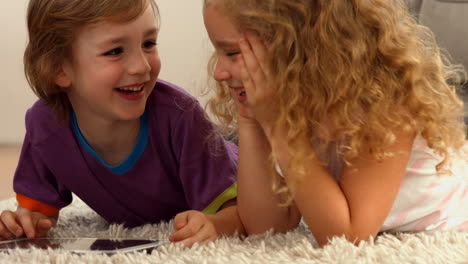 cute siblings using tablet pc