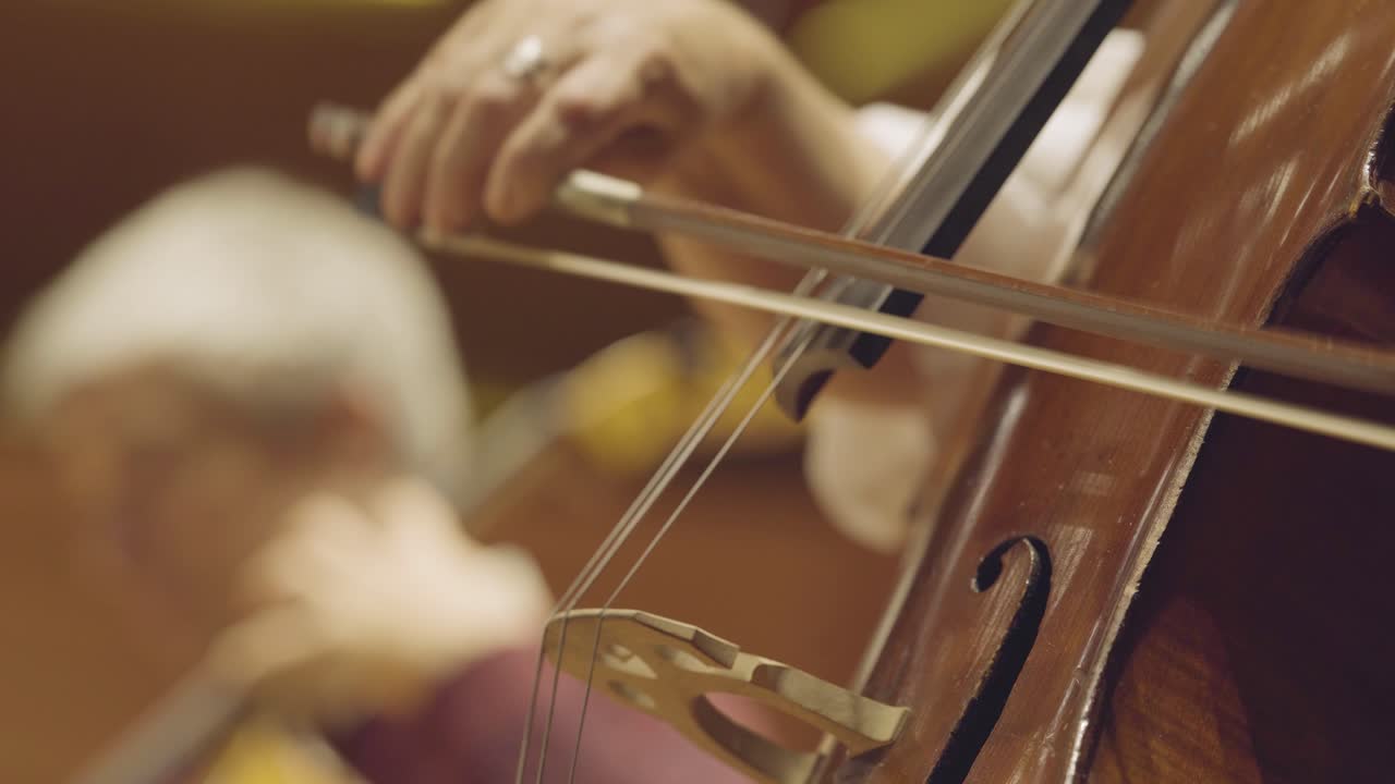 playing a cello, very close