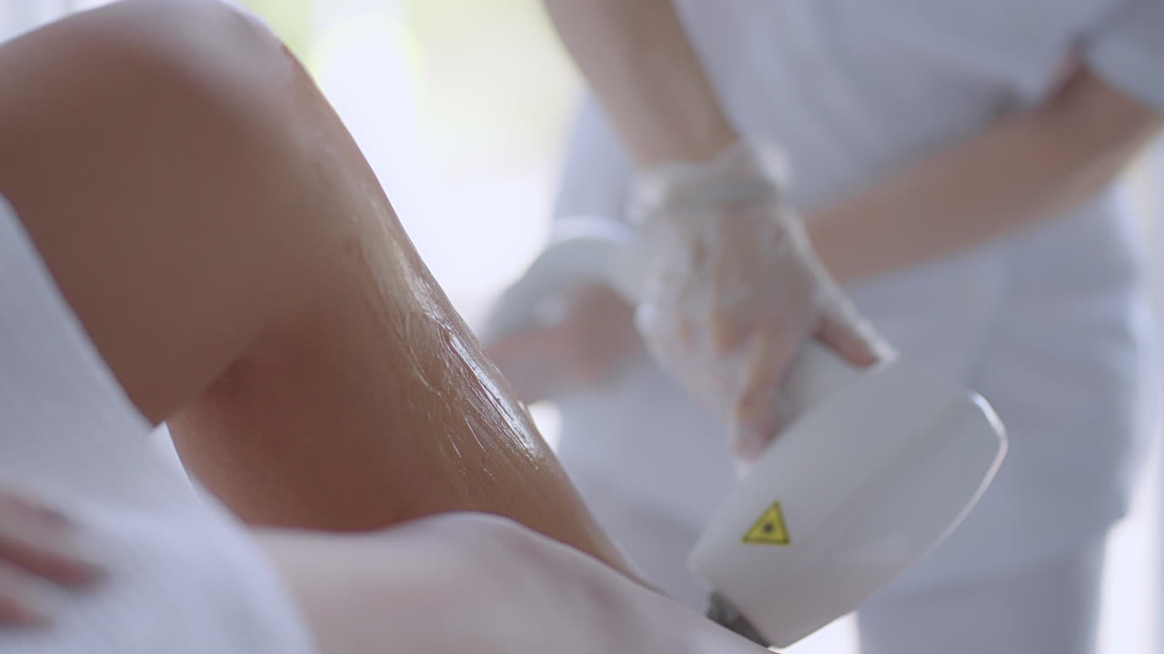 Laser epilation. Woman getting laser hair removal procedure on her legs. Beauty laser treatment salon clinic cosmetology beautician professional profession body care concept