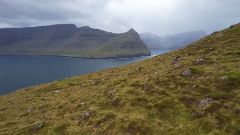 villingardalsfjall mountain slope with view of bordoy and foggy kunoy island in faroe islands