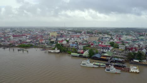 suriname river flowing through heritage city of paramaribo in suriname, aerial view