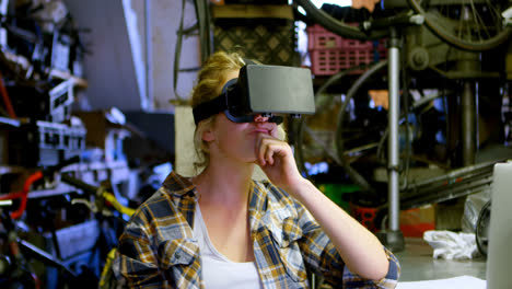 Woman-using-virtual-reality-headset-at-workshop-4k