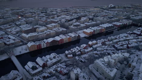 snowy city of trondheim during winter at dawn with nidelva river from above