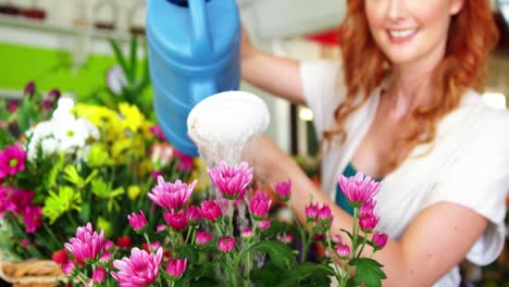 female florist watering flowers