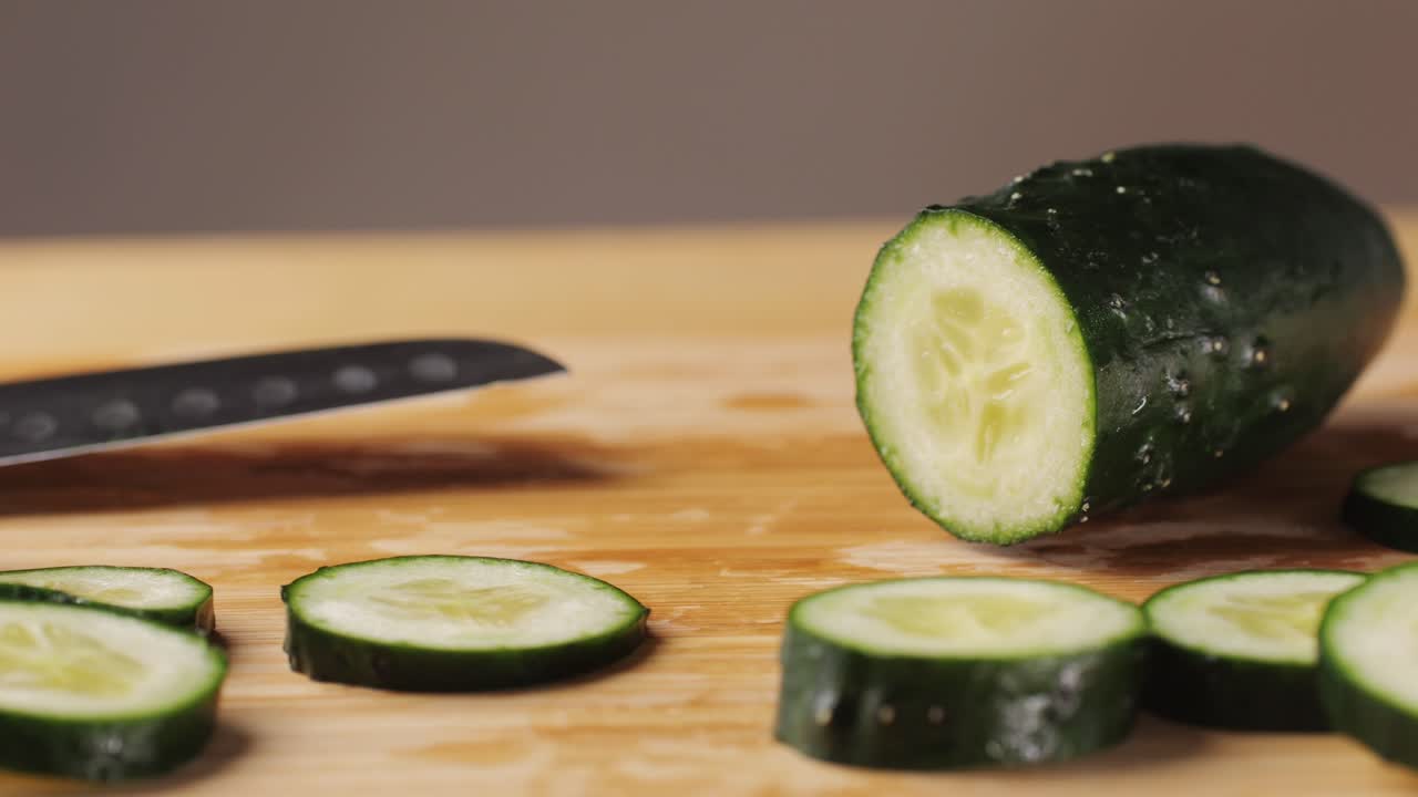 Slicing cucumber vegetables with a knife for cooking, chef cut vegetable.