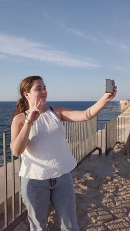 woman enjoying seaside view in historic acre, israel.