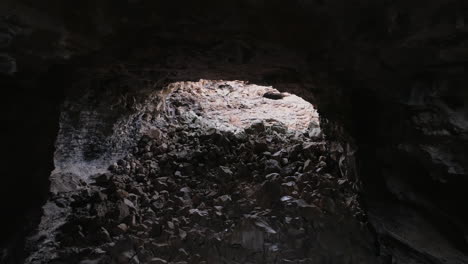 4k aerial moving through inside of massive lave tube rock cave