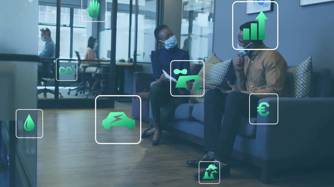 Animation of eco icons over diverse business people wearing face masks in office