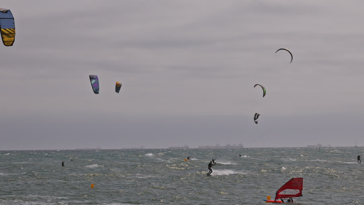 Kitesurfers on a windy day at sea in barcelona