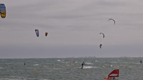 kitesurfers on a windy day at sea in barcelona