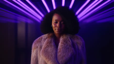 elegant woman in a fur coat with purple neon lights
