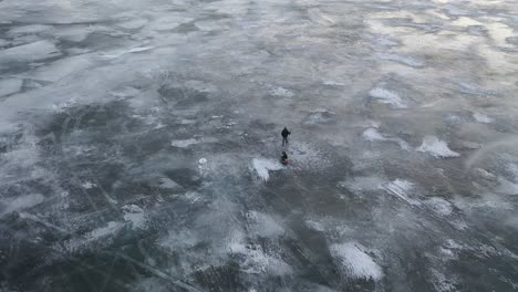 people walking on frozen lake