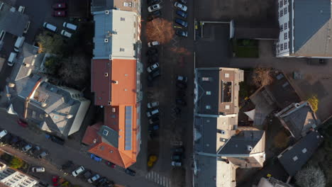 Aerial-birds-eye-overhead-top-down-view-of-straight-street-in-morning-light.-Small-transport-playground-in-front-of-school-building.-Vertical-panning.-Frankfurt-am-Main,-Germany