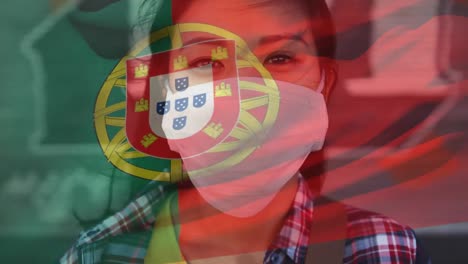 Animation-of-flag-of-portugal-waving-over-woman-wearing-face-mask-during-covid-19-pandemic