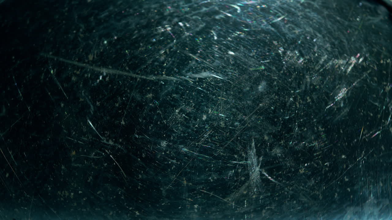 primer plano giratorio de una placa de metal con arañazos profundos que muestran