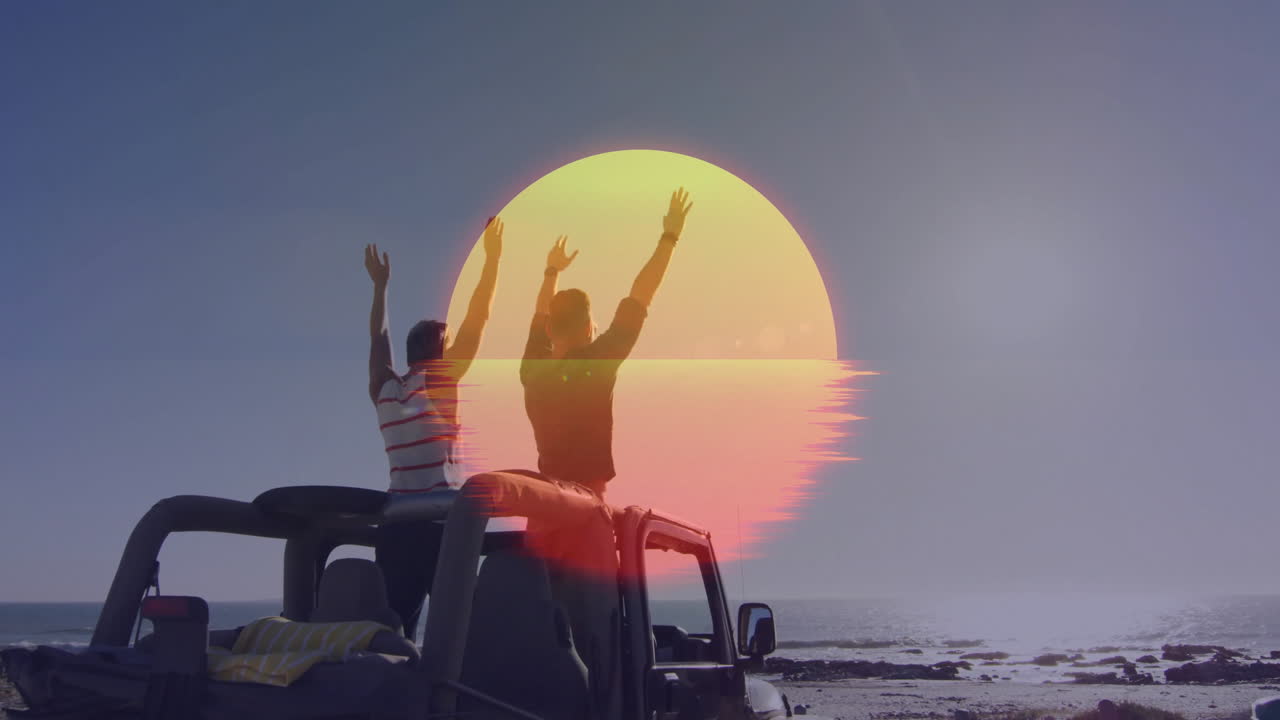 two men raising arms on black jeep at rocky coastline, teaching solar energy with sun graphic