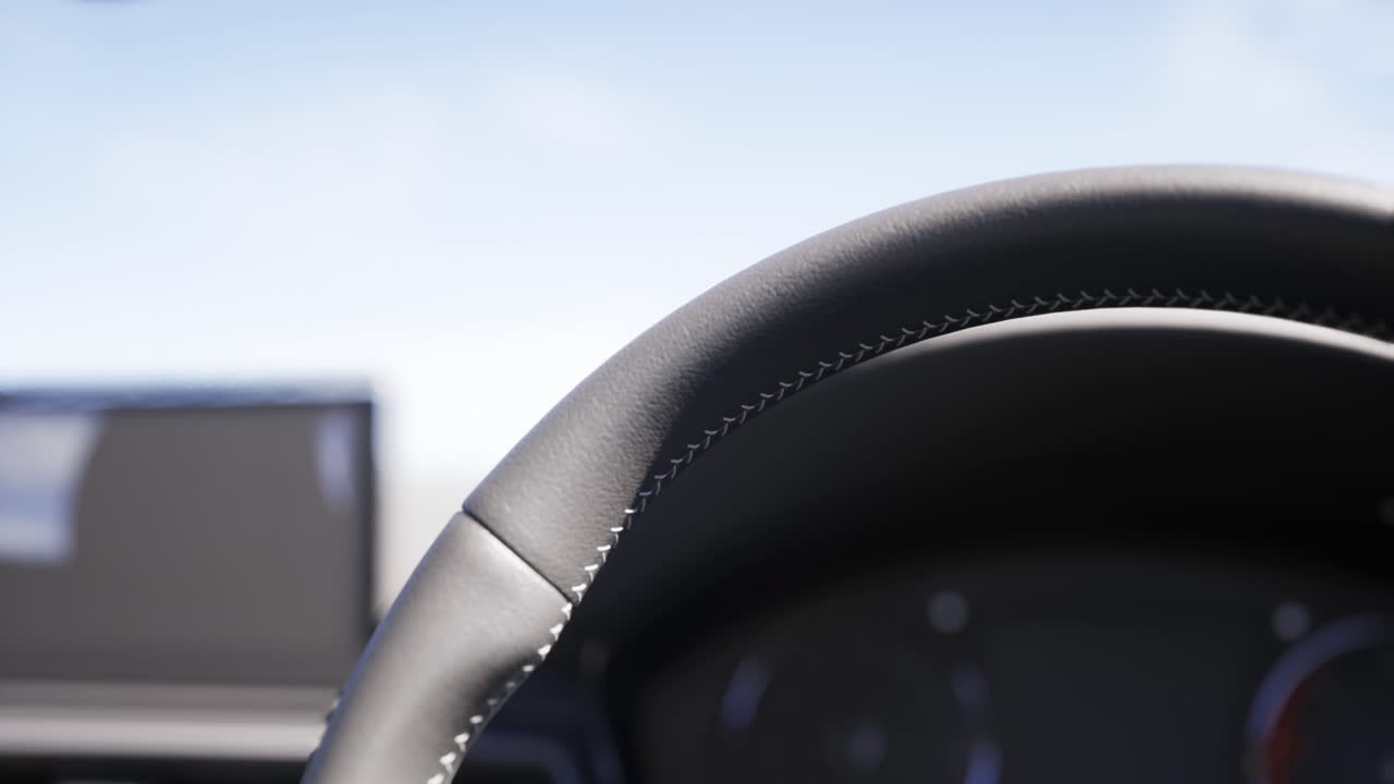 Close view of a car steering wheel with dashboard in the background at sunset