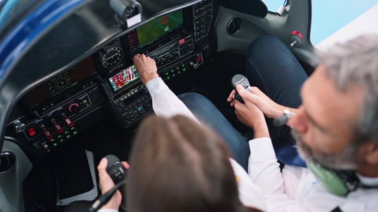 Pilot Instructor Guiding Student in Airplane Cockpit During Flight Training