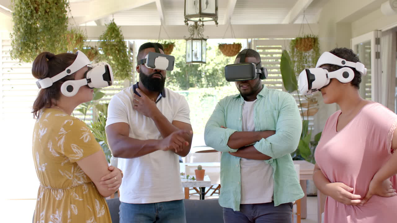 Using VR headsets, group of diverse friends exploring virtual reality together indoors