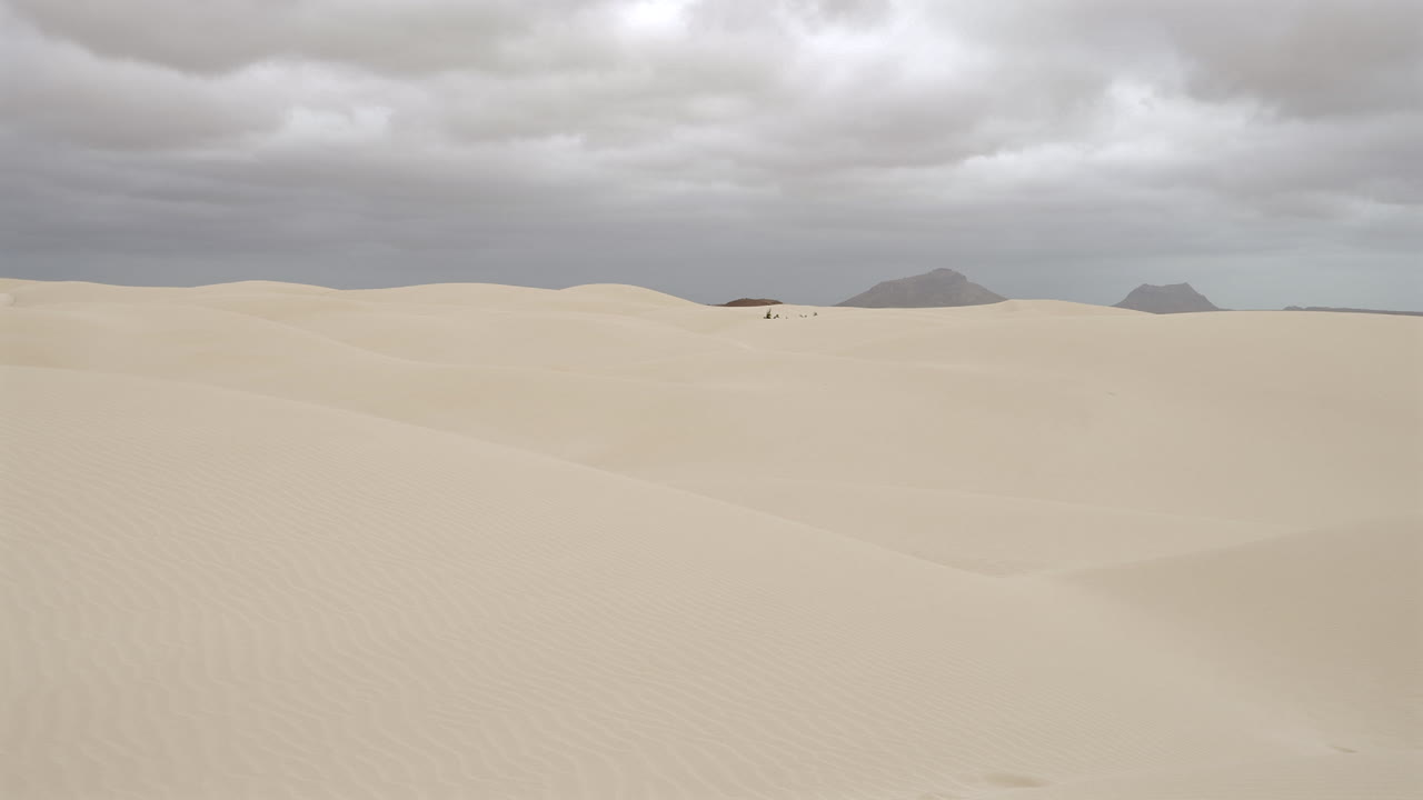 Amazing sand dunes in Viana desert and background mountains at overcast day, Boa vista , Cape Verde