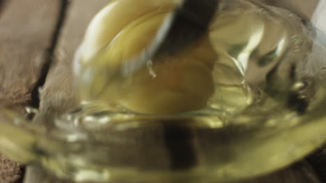 Slow-motion-of-egg-yolk-being-mixed-in-bowl