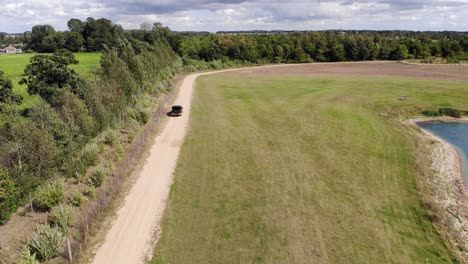 a truck drives along a dusty country road in suffolk, uk