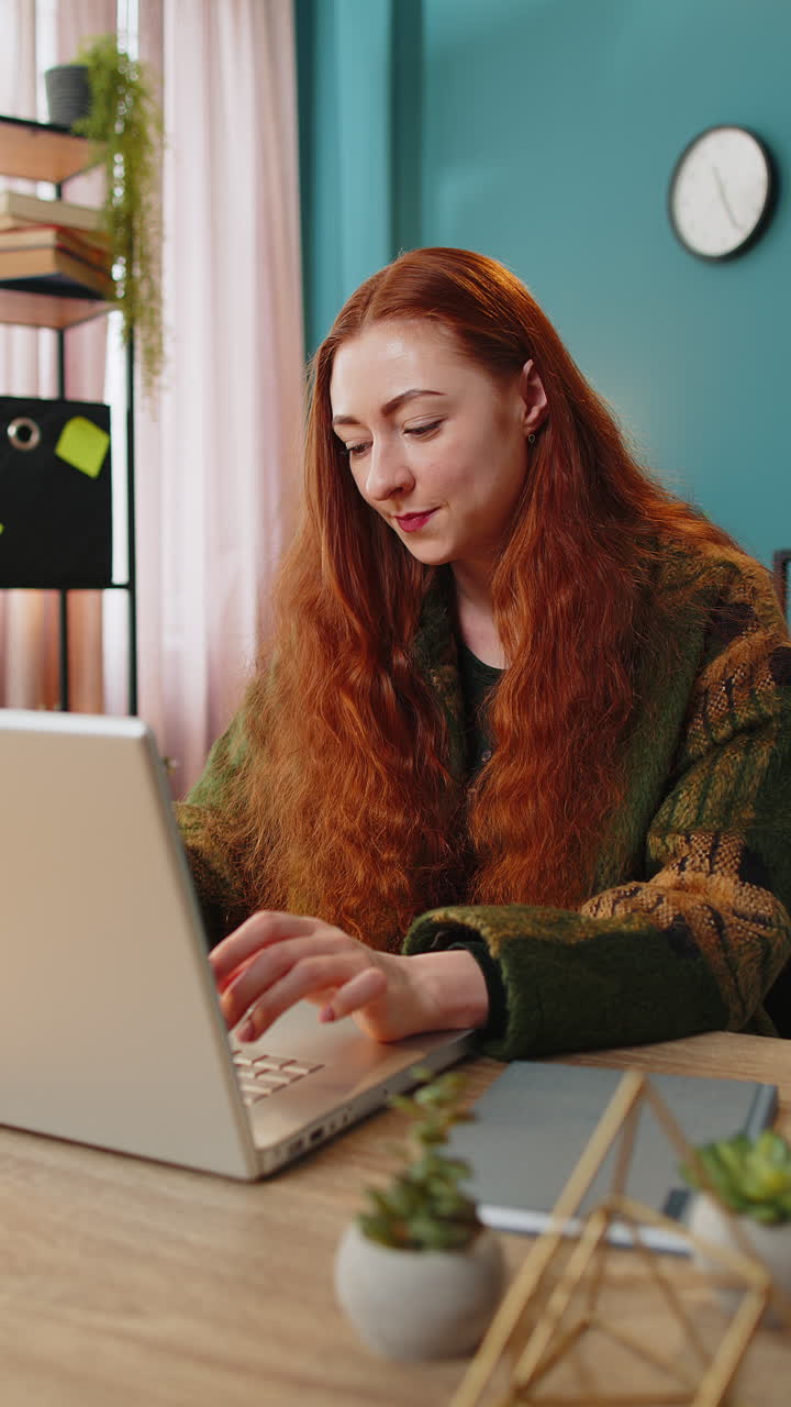 Donna ispirata e felice fa il gesto dell'eureka, alza il dito, avendo avuto un'idea creativa mentre lavora al laptop