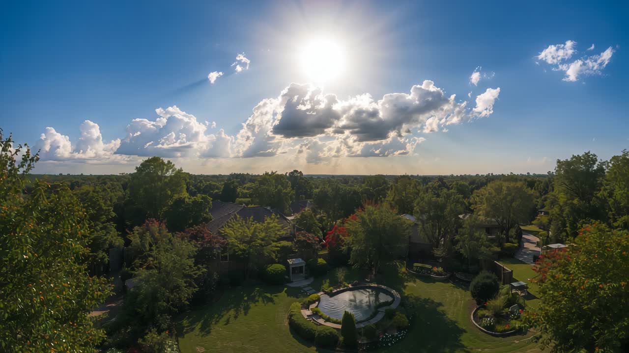 Aerial view of a lush landscape with sun and clouds