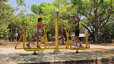 couple working out on a walking machine in a park