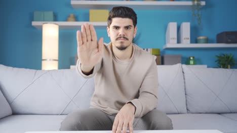 Stop-sign.-Young-man-making-a-stop-sign-with-his-hand.