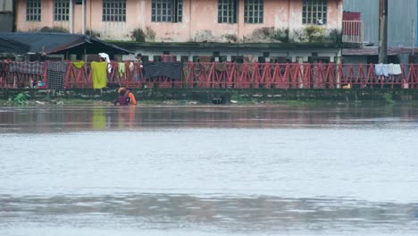 people wading through floodwaters in a south asian city