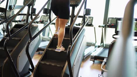 chica haciendo ejercicio de escaleras en el gimnasio