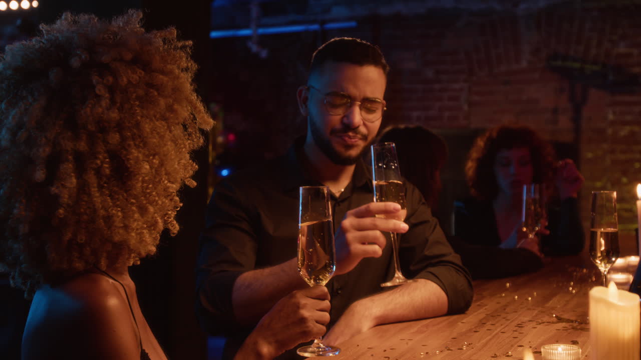 People celebrating at a bar with champagne