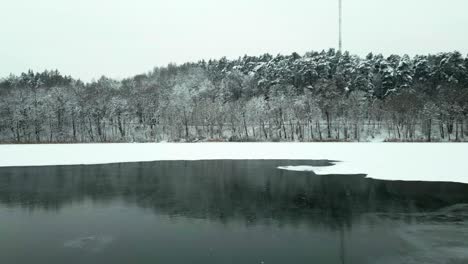 Frozen-lake-and-road-in-a-snowy-forest