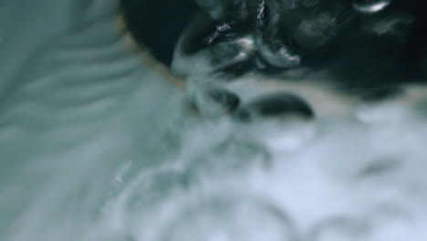 water flow with bubbles runs down through drain hole in sink