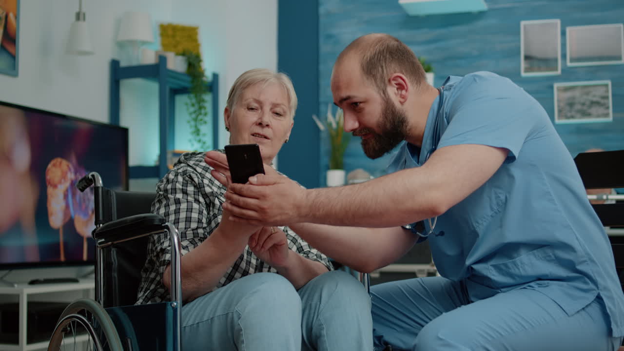 Medical assistant teaching disabled old woman to use smartphone